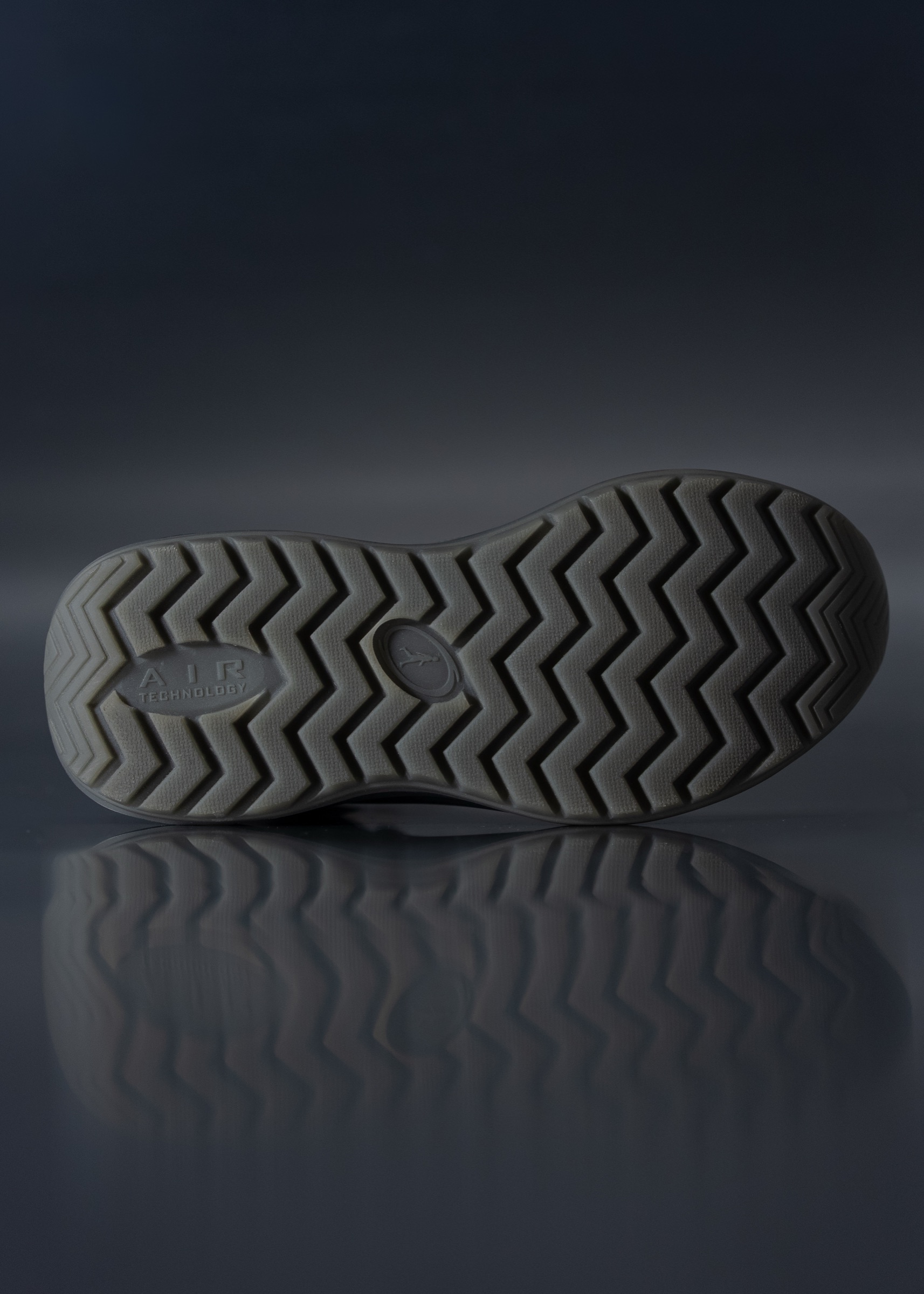 A Riverline tread reflected on a dark surface