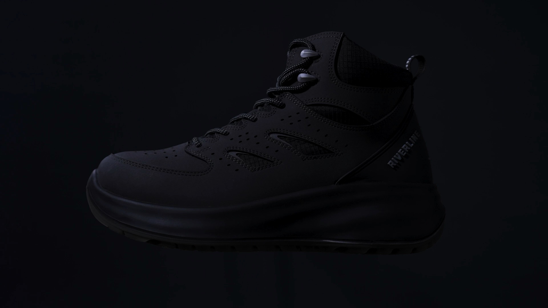 A Riverline boot emerging from darkness